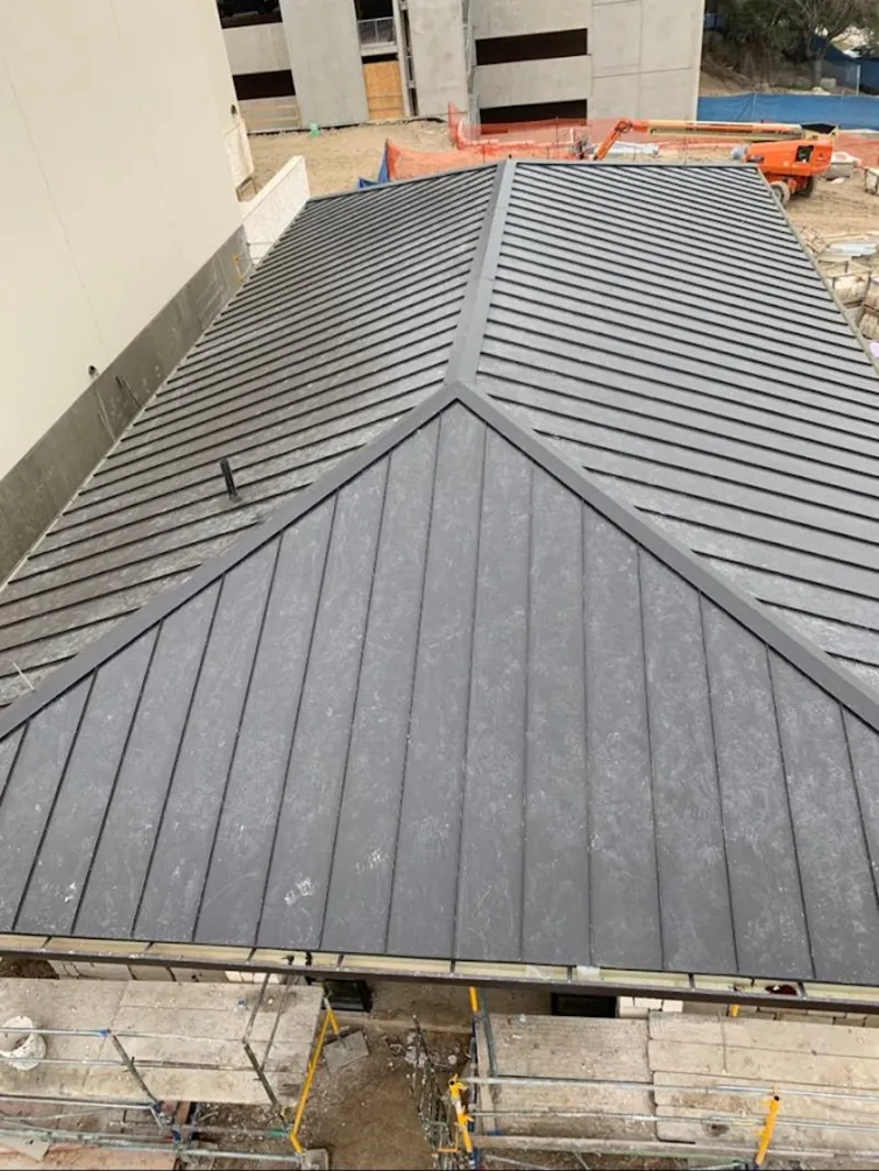 Commercial metal roof construction with crane equipment in The Villages