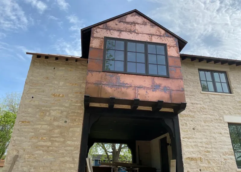 Copper metal panel facade on a stone building for Roof Repair in The Villages